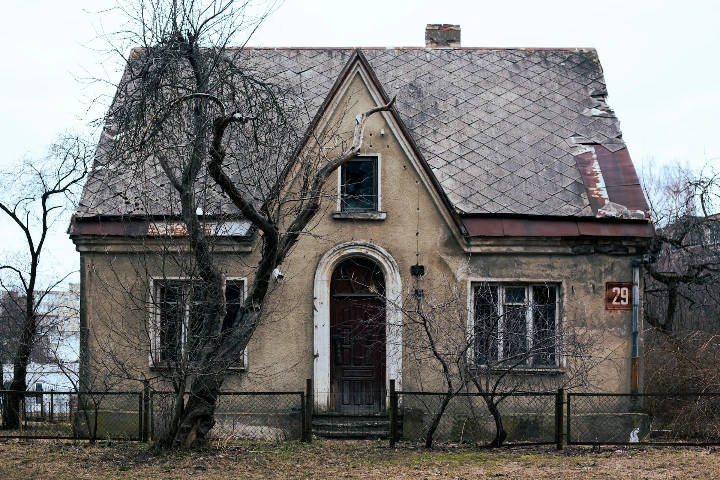 an old house with a fence around it